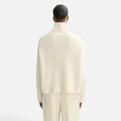 Shop Rescue Spa Girlfriend Turtleneck in cream cashmere with a chunky knit and relaxed fit, back view.