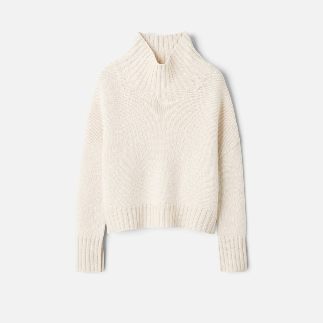 Shop Rescue Spa Girlfriend Turtleneck in cream 100% cashmere with a chunky knit and sleeve slits.