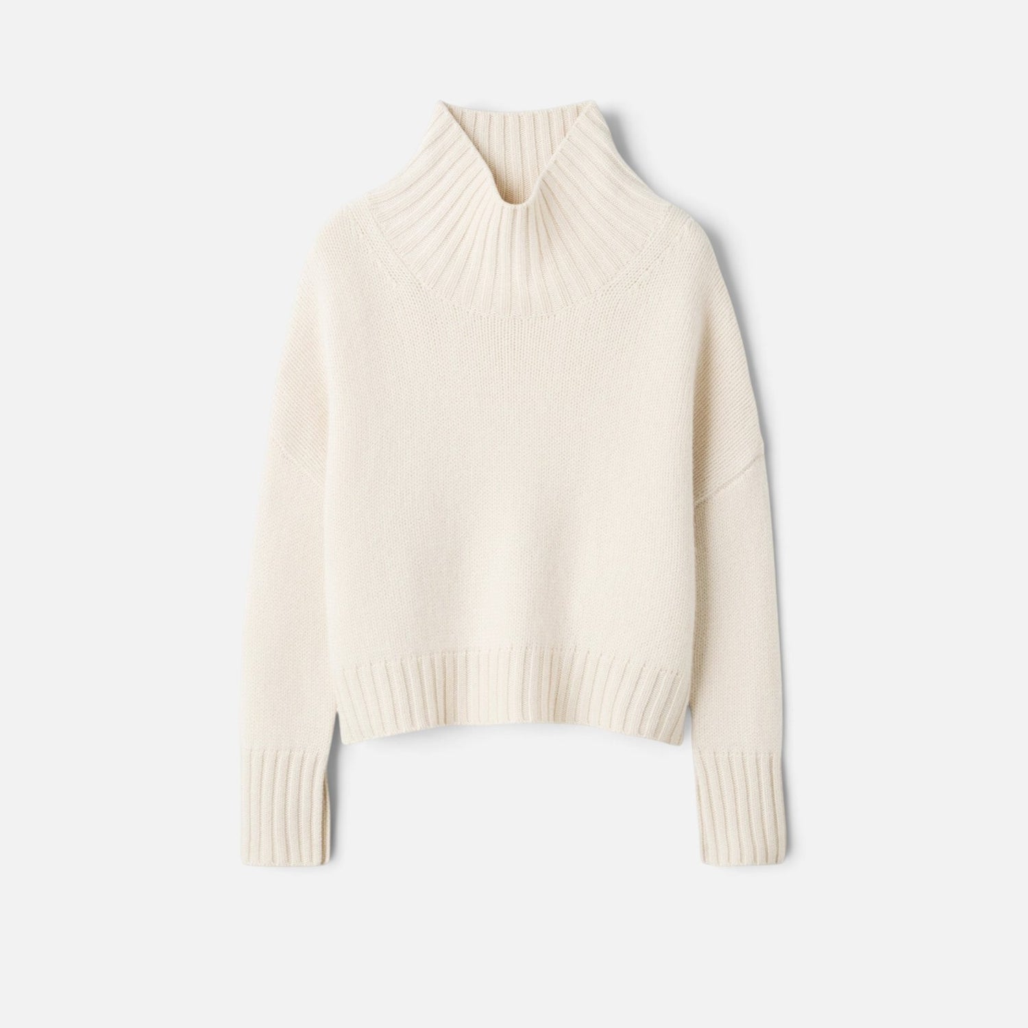 Shop Rescue Spa Girlfriend Turtleneck in cream 100% cashmere with a chunky knit and sleeve slits.