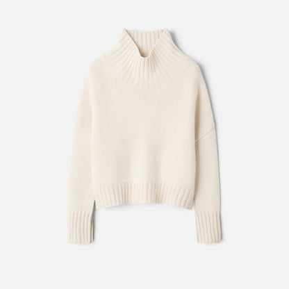 Shop Rescue Spa Girlfriend Turtleneck in cream 100% cashmere with a chunky knit and sleeve slits.
