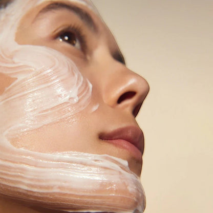 Model applying Shop Rescue Spa Cream Supreme moisturizer in a thick, creamy white layer for skin rejuvenation.