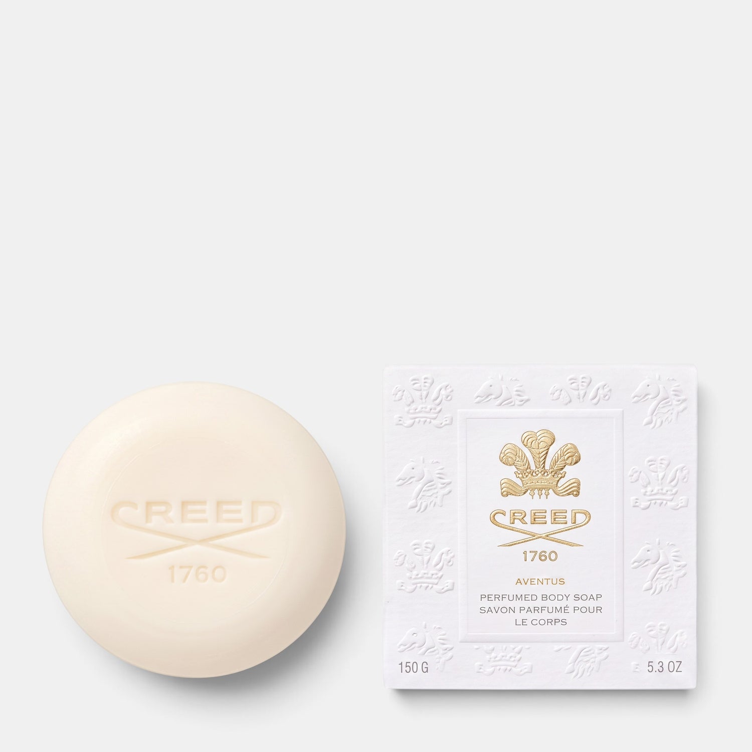 Shop Rescue Spa Creed Aventus perfumed body soap bar with embossed logo next to its elegant white branded packaging.