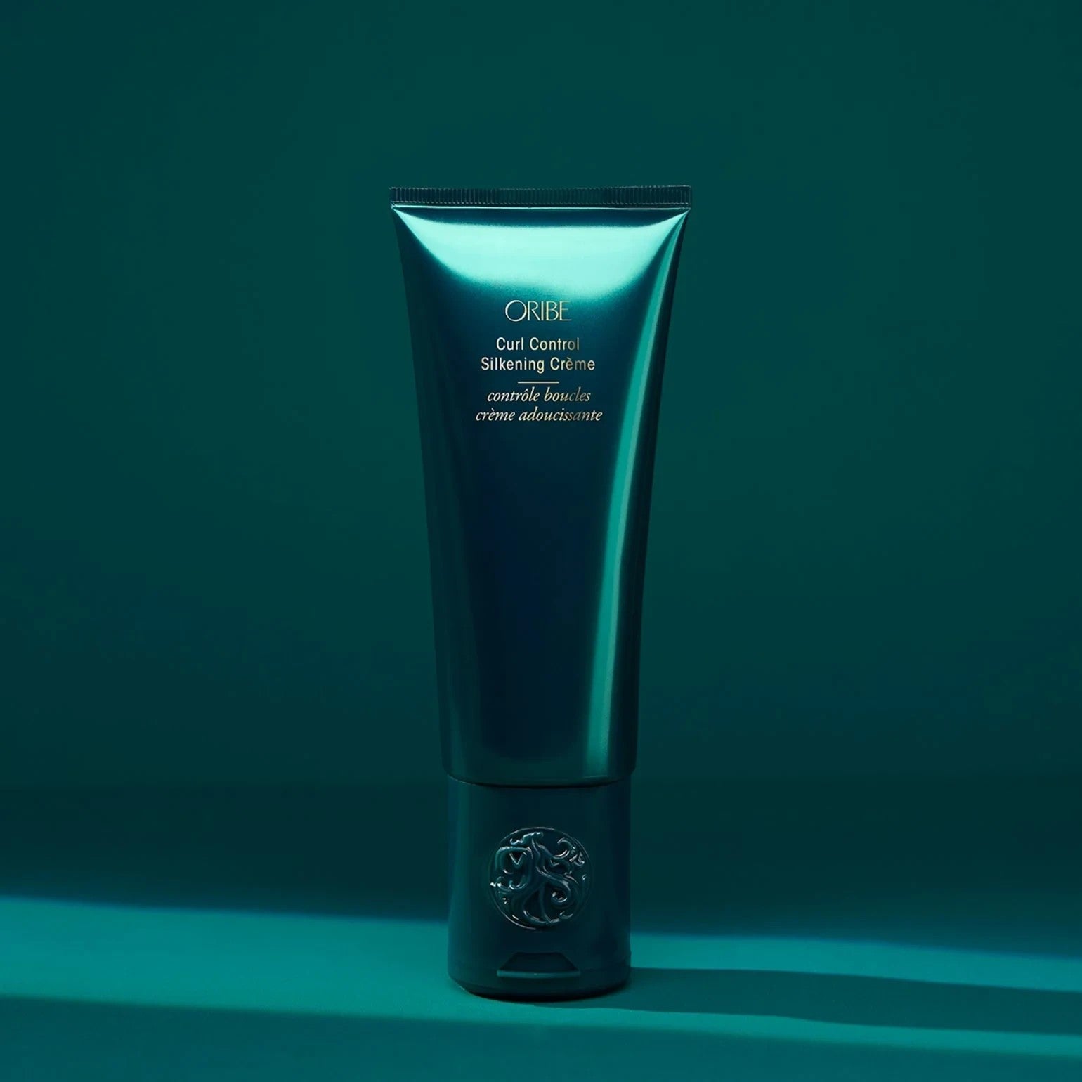 Shop Rescue Spa Oribe Curl Control Silkening Creme for defining curls with avocado, apricot, and coconut oils.