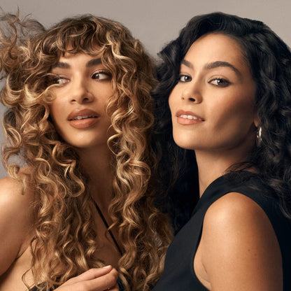 Shop Rescue Spa Curl Control Silkening Creme on models with defined blonde and dark curly hair.