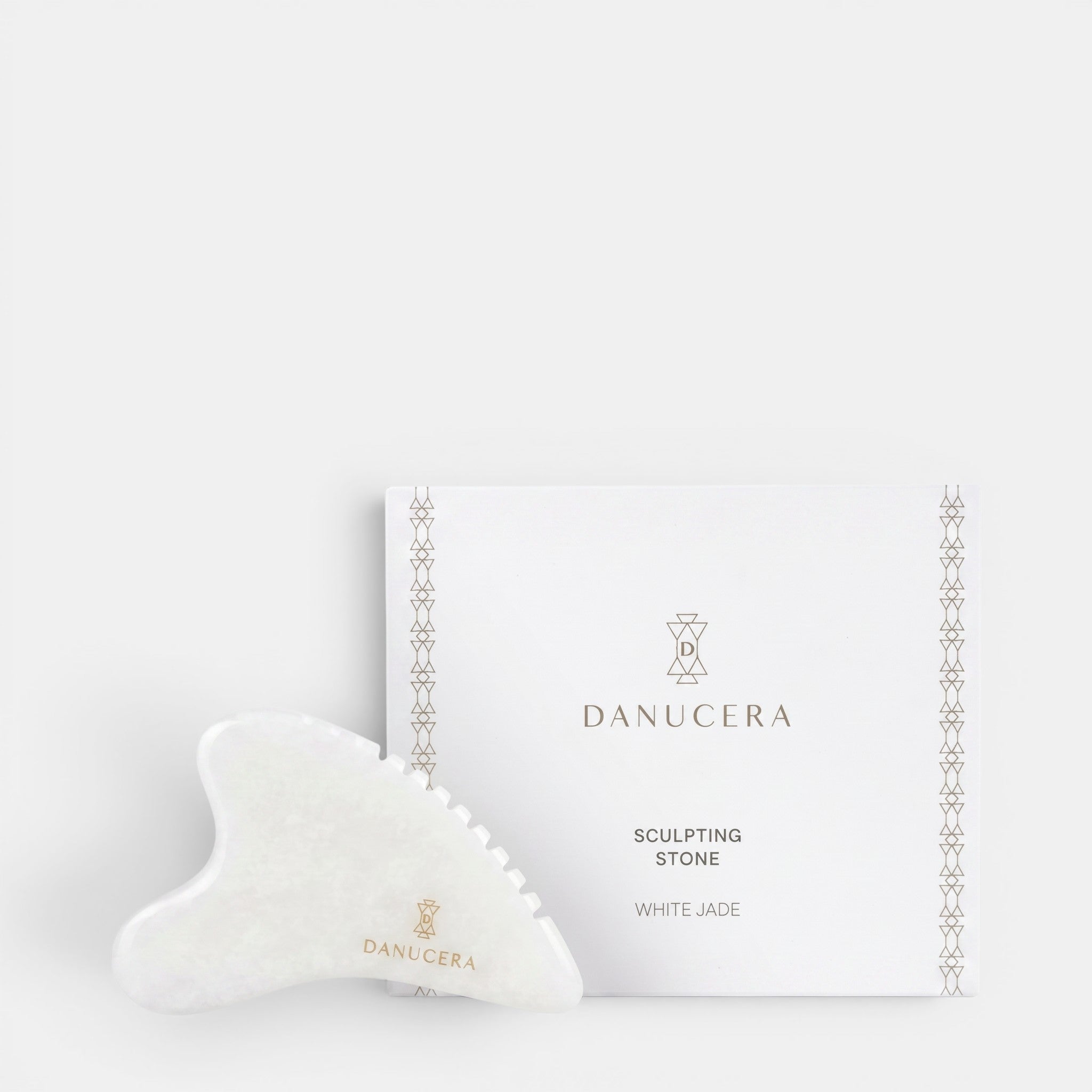 Shop Rescue Spa DANUCERA Sculpting Stone made of white jade for facial massage, shown with its branded white box.