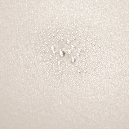 Shop Rescue Spa Serene Scalp Densifying Treatment Spray with water droplets on a textured beige surface
