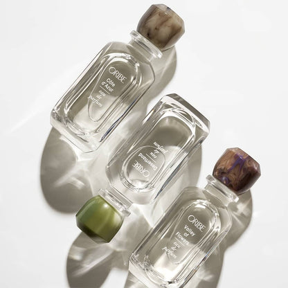 Shop Rescue Spa Desertland Eau De Parfum, clear glass bottle with marbled brown cap and green accents.