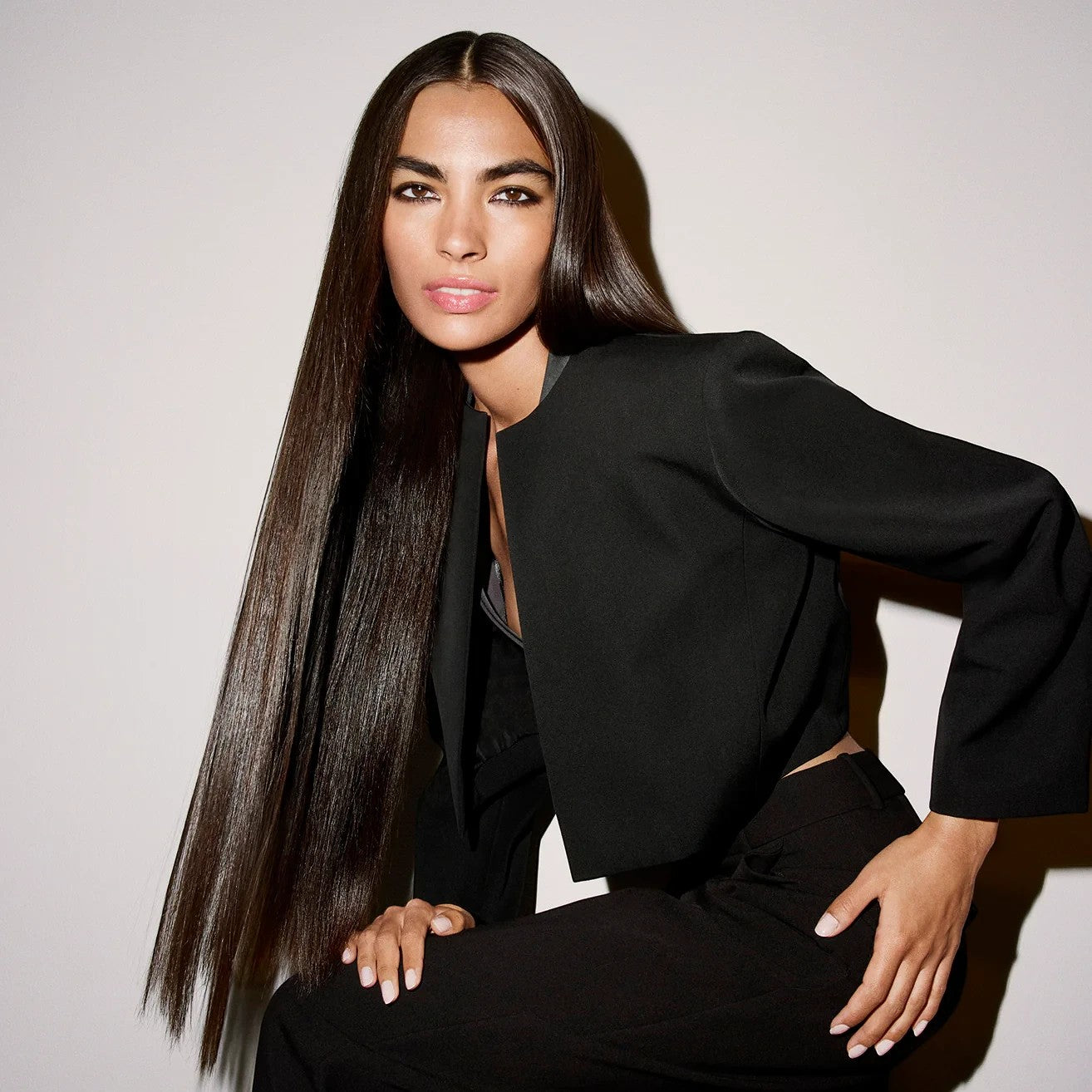 Shop Rescue Spa Run-Through Detangling Primer model with long, silky, straight hair in a black blazer