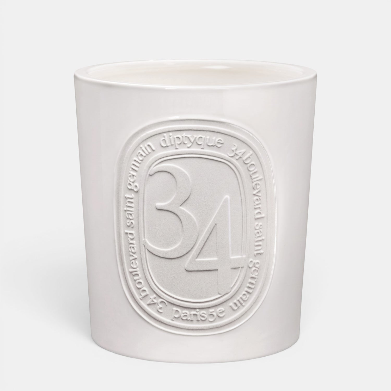 Shop Rescue Spa Diptyque 34 Boulevard Saint Germain scented candle in a white opaline vessel with embossed branding.
