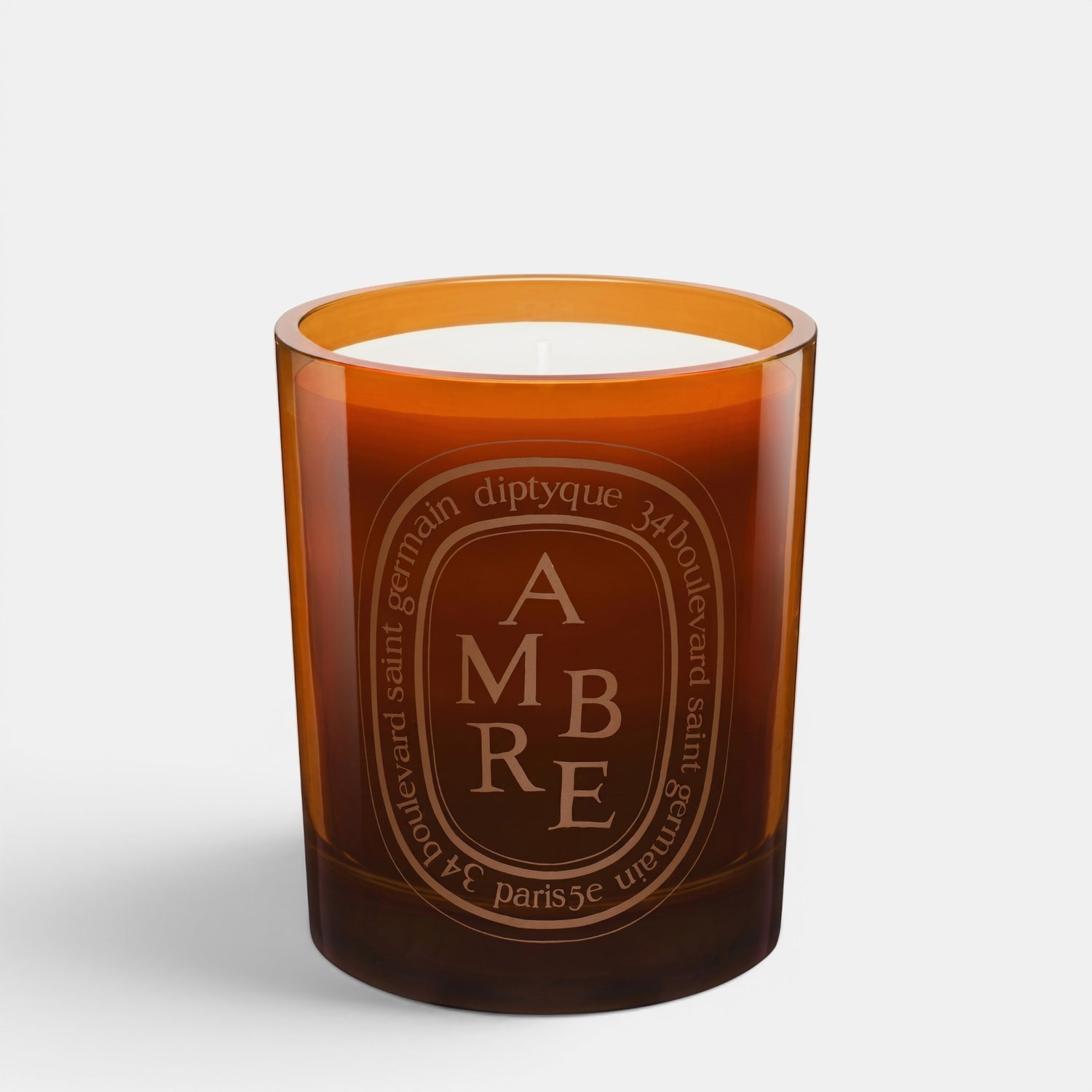 Shop Rescue Spa Diptyque Ambre scented candle in a brown glass jar with woody, spicy fragrance notes.