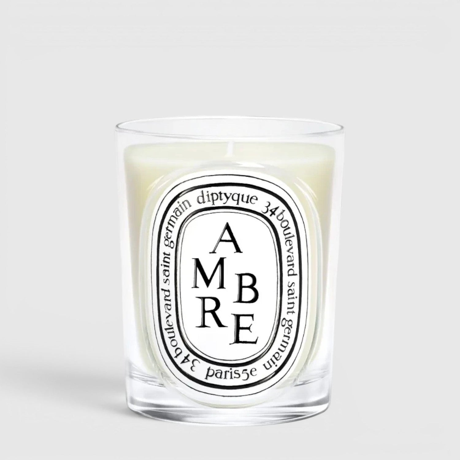 Shop Rescue Spa Diptyque Ambre scented candle in a clear glass vessel with a signature oval label