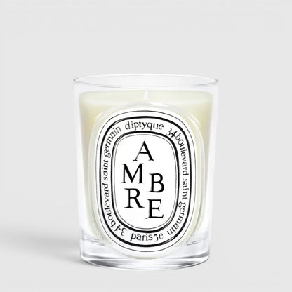 Shop Rescue Spa Diptyque Ambre scented candle in a clear glass vessel with a signature oval label