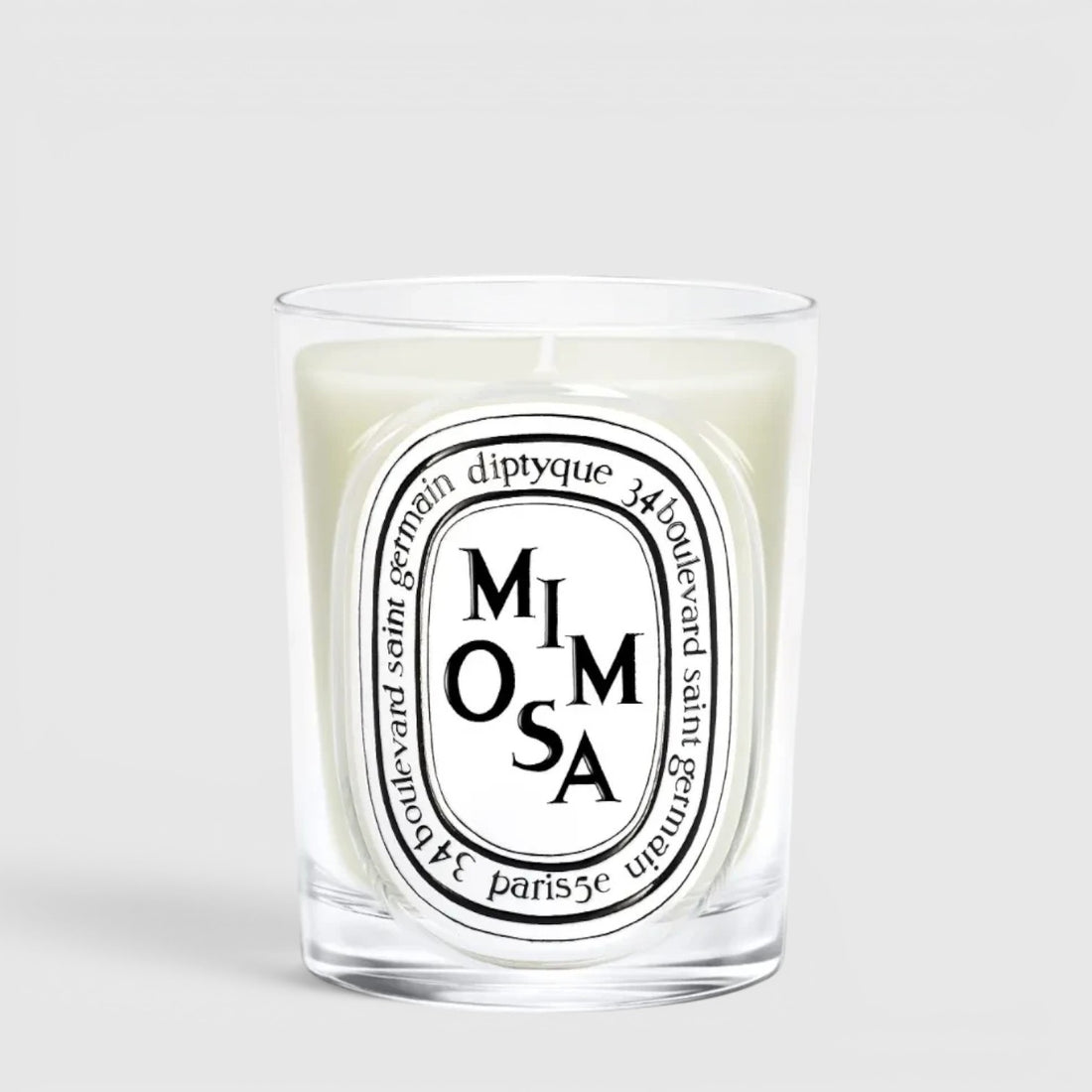 Shop Rescue Spa Diptyque Mimosa scented candle in a clear glass vessel with a signature oval label