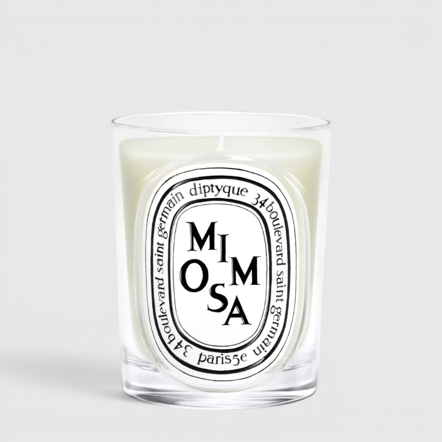 Shop Rescue Spa Diptyque Mimosa scented candle in a clear glass vessel with a signature oval label