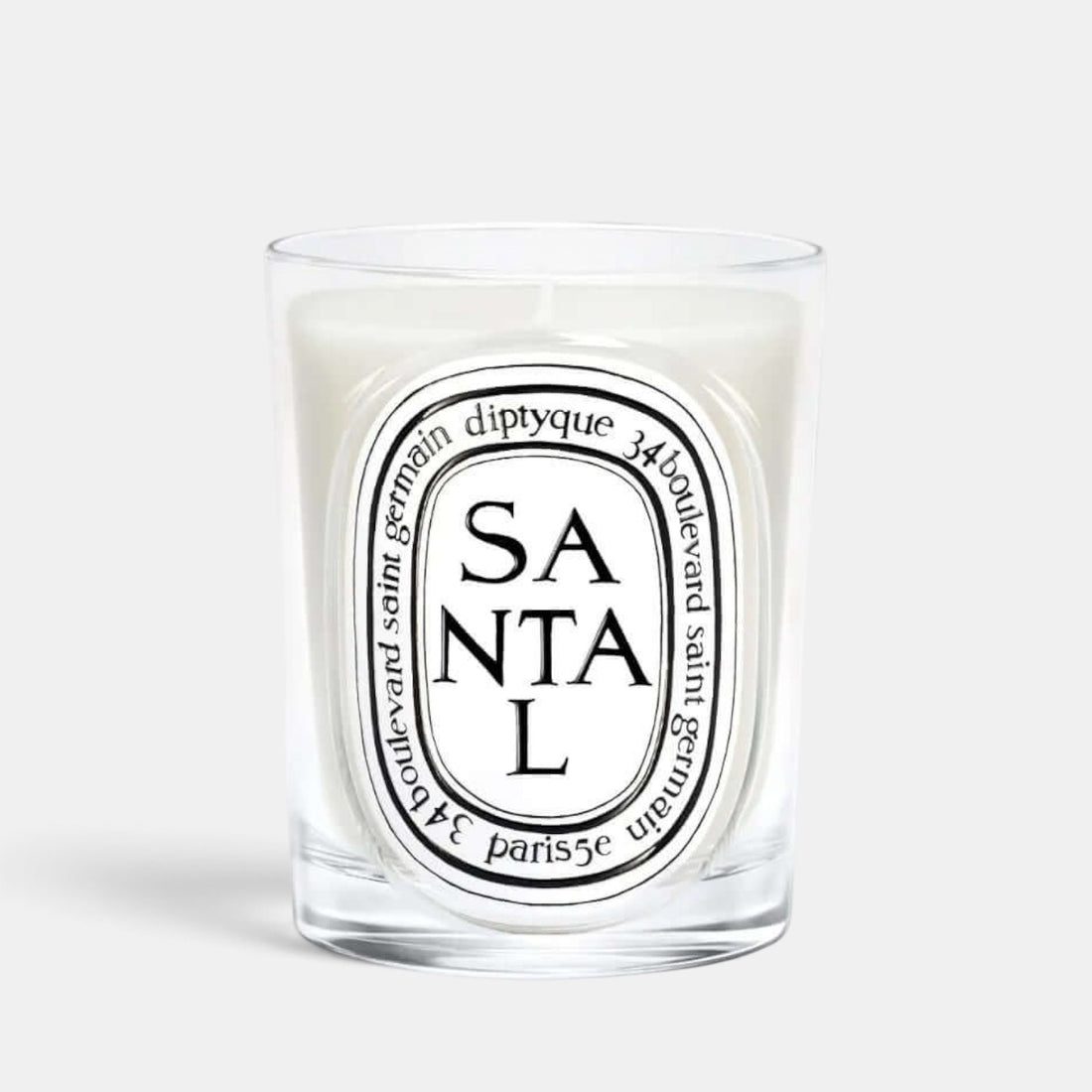 Shop Rescue Spa Diptyque Santal scented candle in a clear glass vessel with a white wax finish