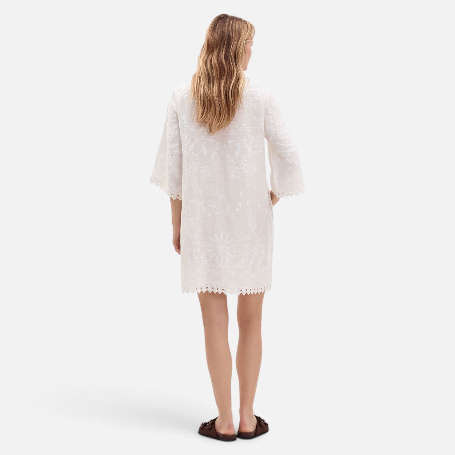 Back view of Shop Rescue Spa Aigue-Marine short white embroidered linen dress with 3/4 sleeves and scalloped hem.