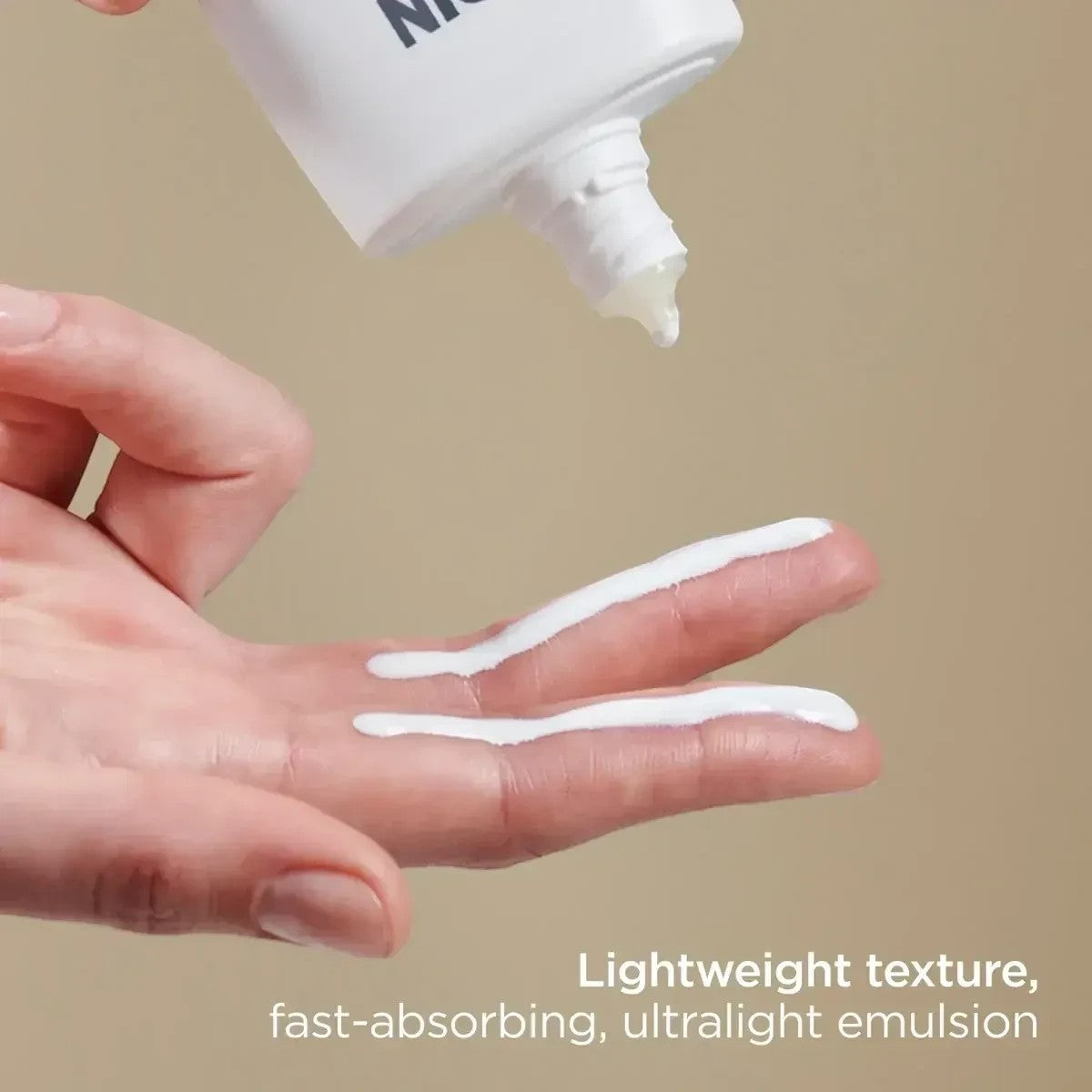 Shop Rescue Spa Eryfotona Actinica mineral sunscreen emulsion being applied to fingers, showing lightweight texture.