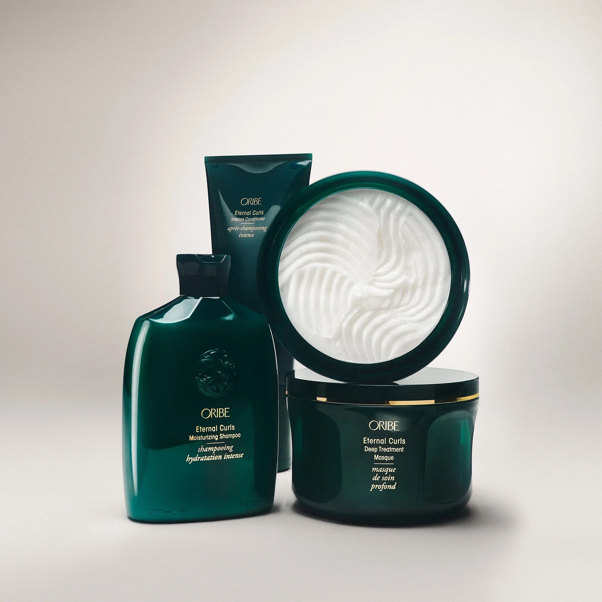 Shop Rescue Spa ORIBE Eternal Curls Deep Treatment Masque in a dark green jar with gold trim, enriched with coconut and almond oils.