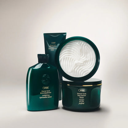 Shop Rescue Spa ORIBE Eternal Curls Deep Treatment Masque in a dark green jar with gold trim, enriched with coconut and almond oils.