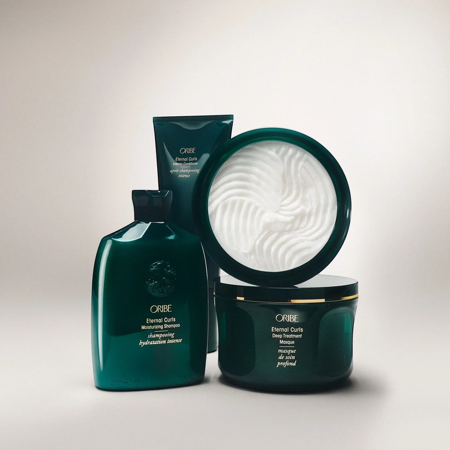 Shop Rescue Spa ORIBE Eternal Curls Deep Treatment Masque in a dark green jar with gold trim, enriched with coconut and almond oils.