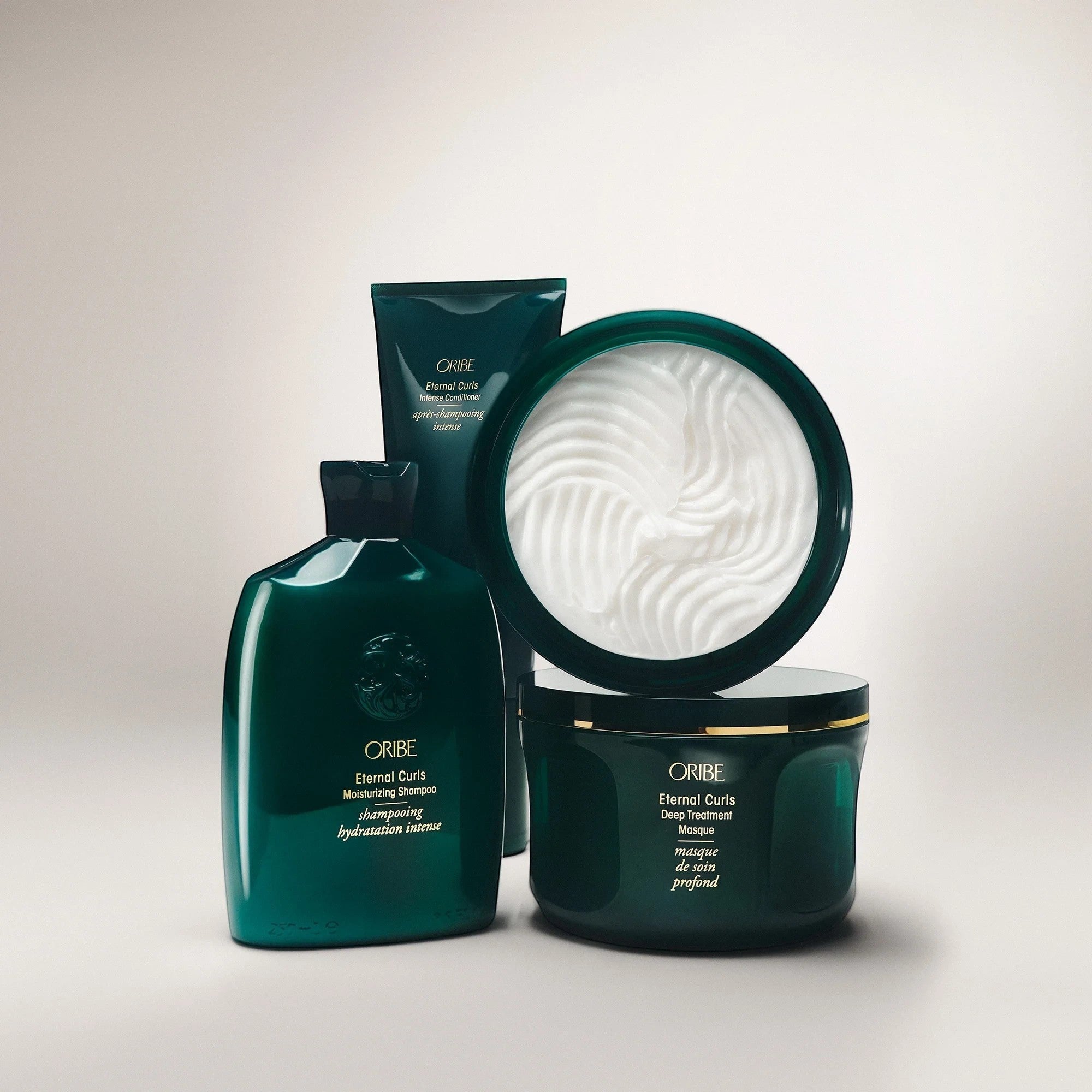 Shop Rescue Spa ORIBE Eternal Curls Deep Treatment Masque in a dark green jar with gold trim, enriched with coconut and almond oils.