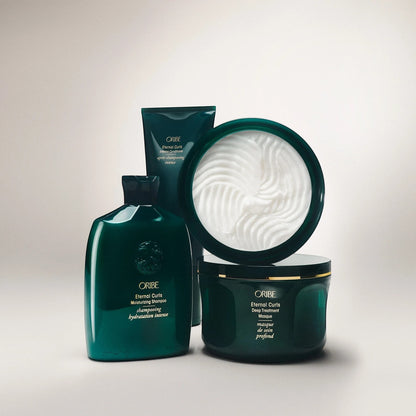 Shop Rescue Spa ORIBE Eternal Curls Deep Treatment Masque in a dark green jar with gold trim, enriched with coconut and almond oils.