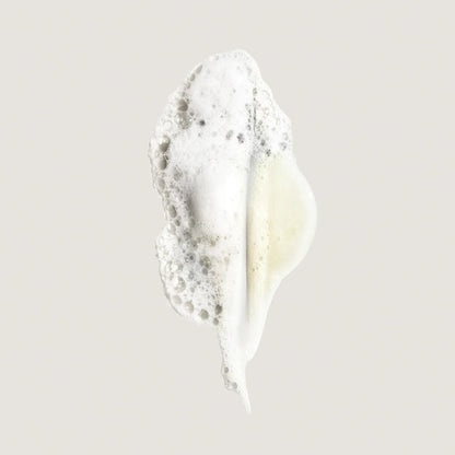 Shop Rescue Spa Eternal Curls Moisturizing Shampoo foam swatch with white bubbles and a hint of yellow