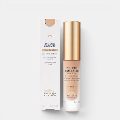 Shop Rescue Spa Biologique Recherche Eye Care Concealer No 2 in a sleek bottle with gold cap and matching box.