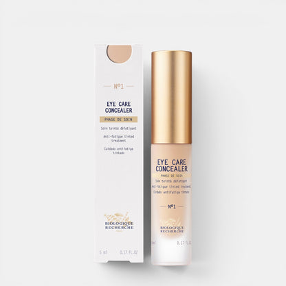 Shop Rescue Spa Eye Care Concealer in a sleek bottle with gold cap next to its white product box.