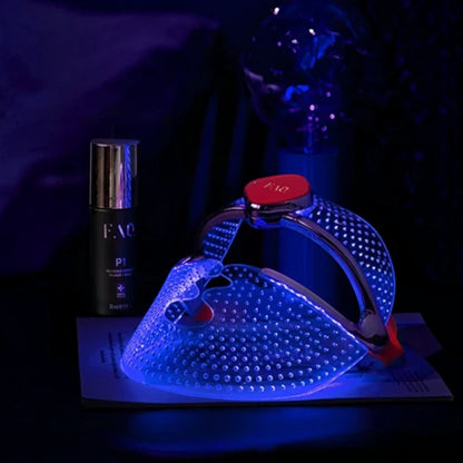 Shop Rescue Spa FAQ 201 silicone LED face mask glowing with blue light for anti-acne treatment on a dark surface