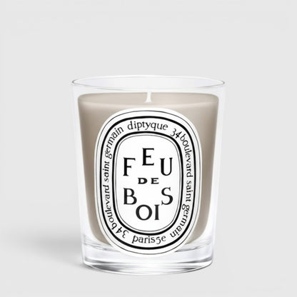 Shop Rescue Spa Diptyque Feu de Bois scented candle in a clear glass vessel with a signature oval label.
