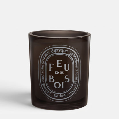 Shop Rescue Spa Feu De Bois scented candle in a dark glass jar with a white oval label featuring smoky wood notes.