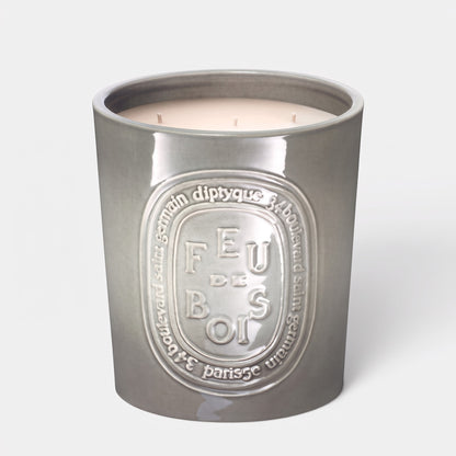 Shop Rescue Spa Feu De Bois scented candle in a grey ceramic vessel with embossed branding