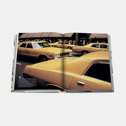 Shop Rescue Spa Fifth Avenue book open to a page showing vintage yellow taxis on a busy New York City street