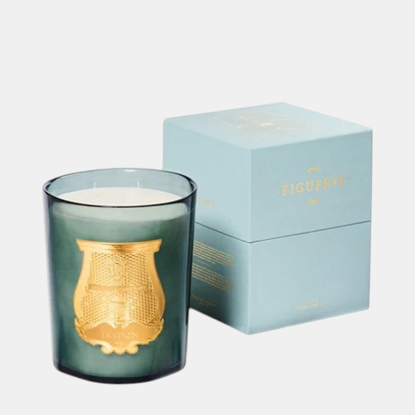 Shop Rescue Spa Figuerie Collection candle in a dark green glass jar with gold emblem, next to a light blue box.
