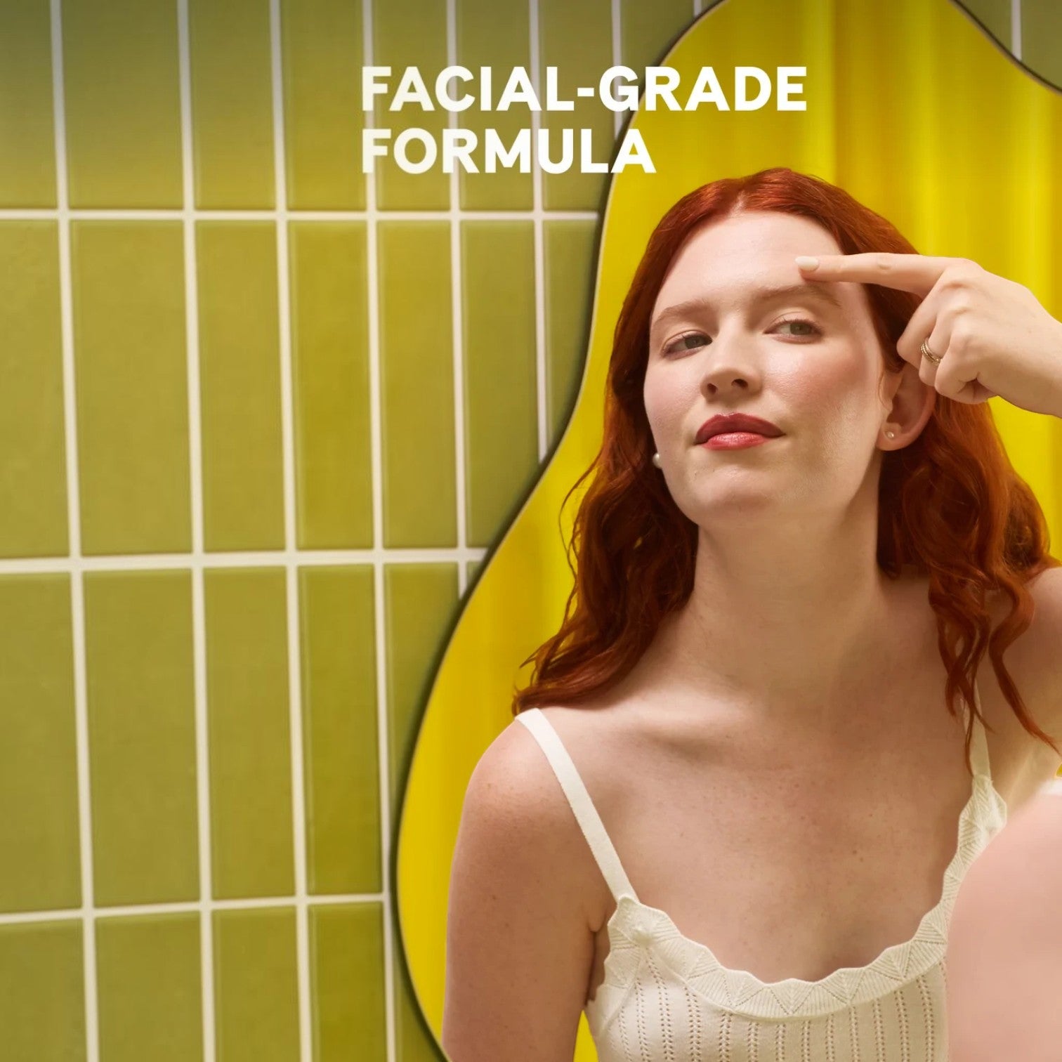Shop Rescue Spa Flash Repair Jelly applied to the forehead by a woman with red hair in a green tiled bathroom