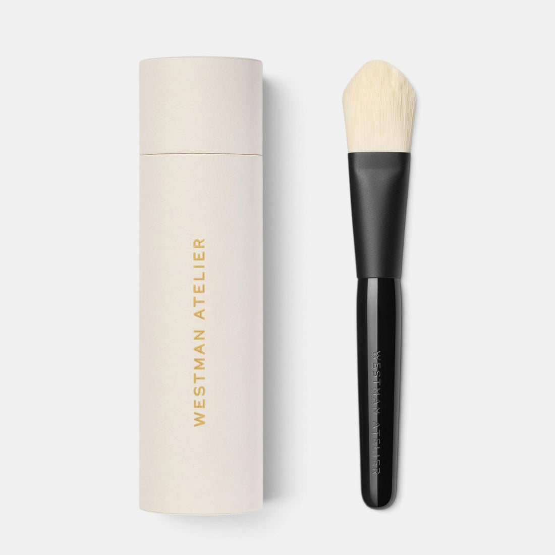 Shop Rescue Spa Westman Atelier foundation brush with a black lacquered handle and matching cylindrical storage case.