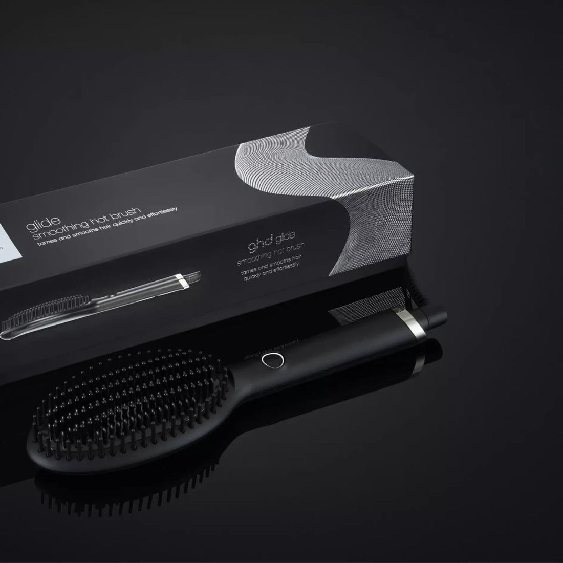 Shop Rescue Spa ghd Glide smoothing hot brush with ceramic bristles and black packaging on a dark background