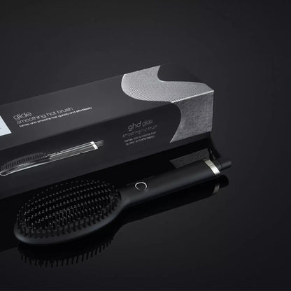 Shop Rescue Spa ghd Glide smoothing hot brush with ceramic bristles and black packaging on a dark background