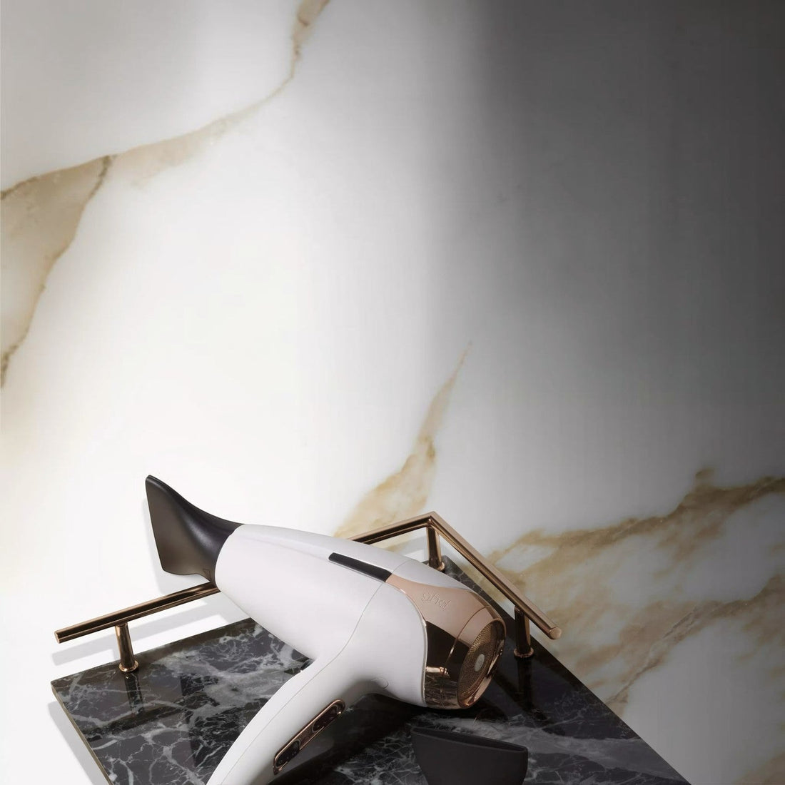 Shop Rescue Spa ghd helios professional hair dryer in sparkling white with rose gold accents on a marble tray