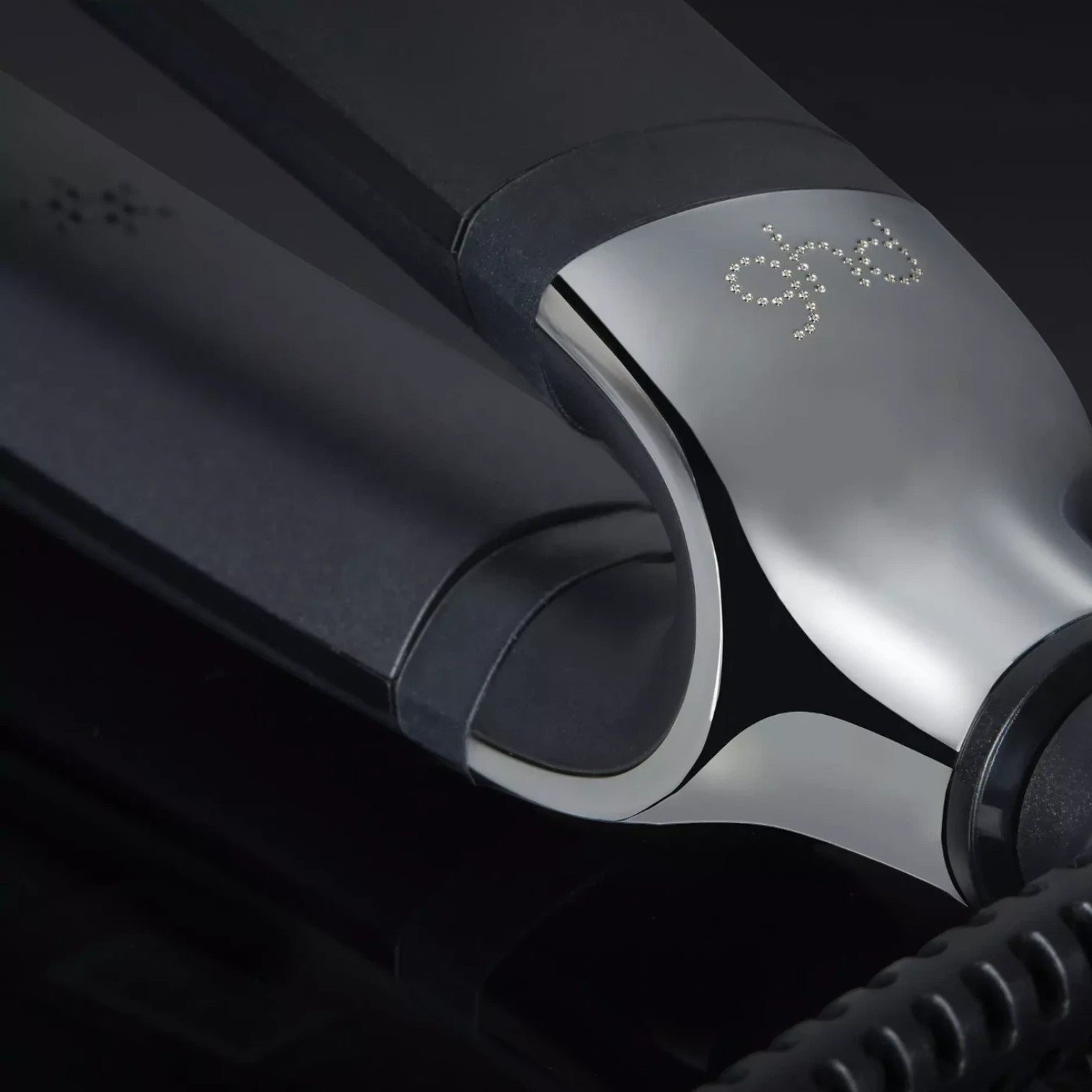 Shop Rescue Spa ghd Platinum+ Styler flat iron featuring a sleek black finish and metallic wishbone hinge detail.