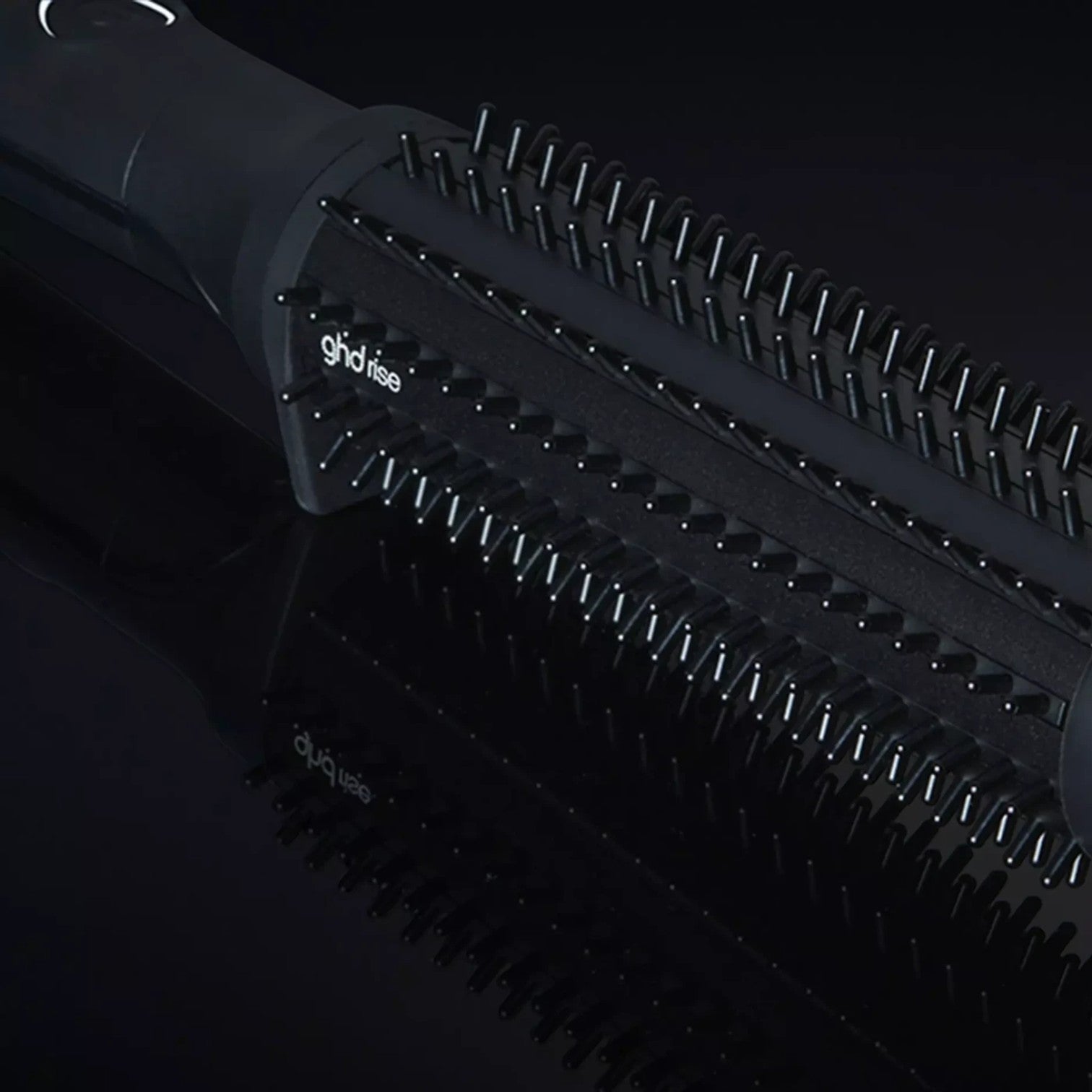 Shop Rescue Spa ghd rise volumizing hot brush with black barrel and nylon bristles for root lift on dark background