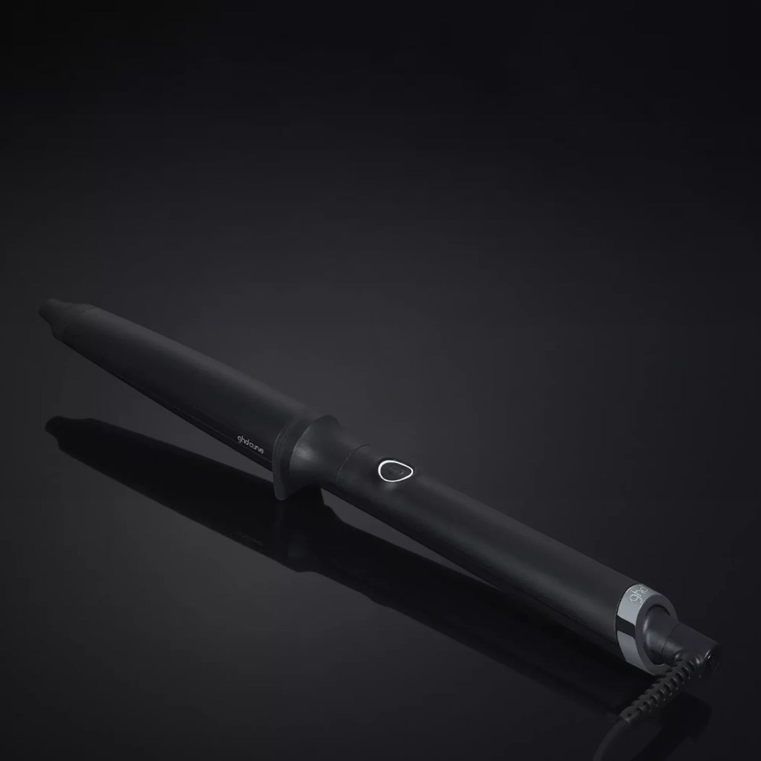Shop Rescue Spa ghd curve creative curl tapered wand in matte black for beachy waves on a dark reflective surface
