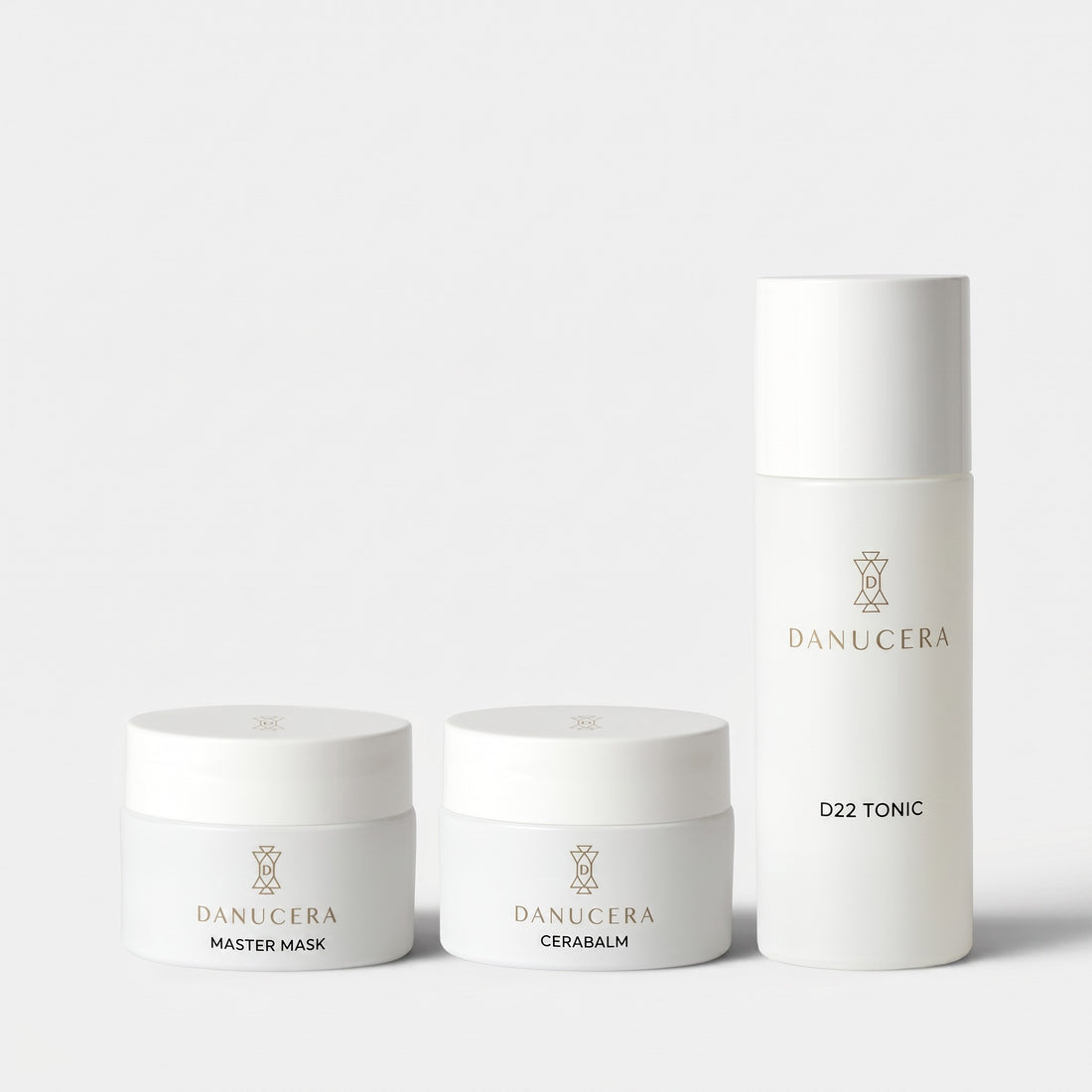 Shop Rescue Spa The Glow Trio skincare set featuring Danucera Master Mask, Cerabalm, and D22 Tonic in white packaging.