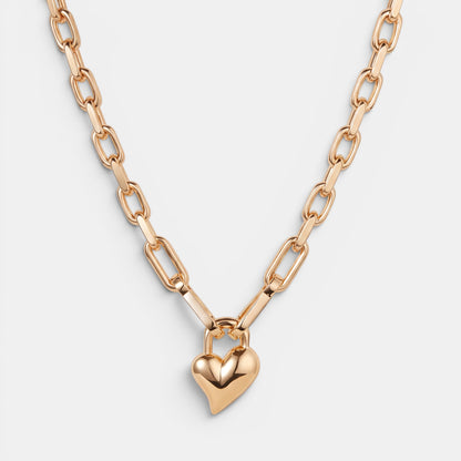 Shop Rescue Spa gold padlock heart pendant necklace with faceted chain links in a high-polish finish.