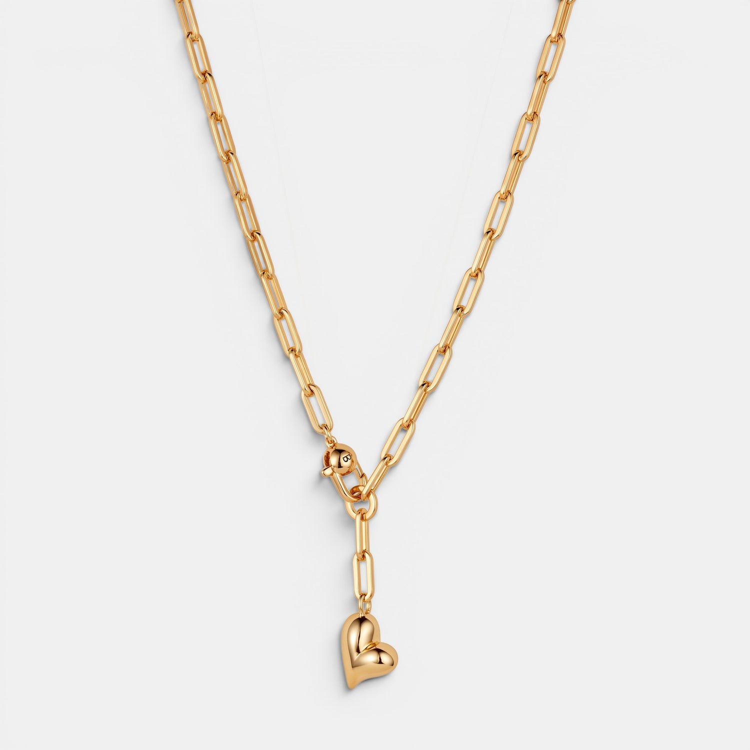 Jenny Bird high-polish gold puffy heart charm necklace on a chunky paperclip link chain