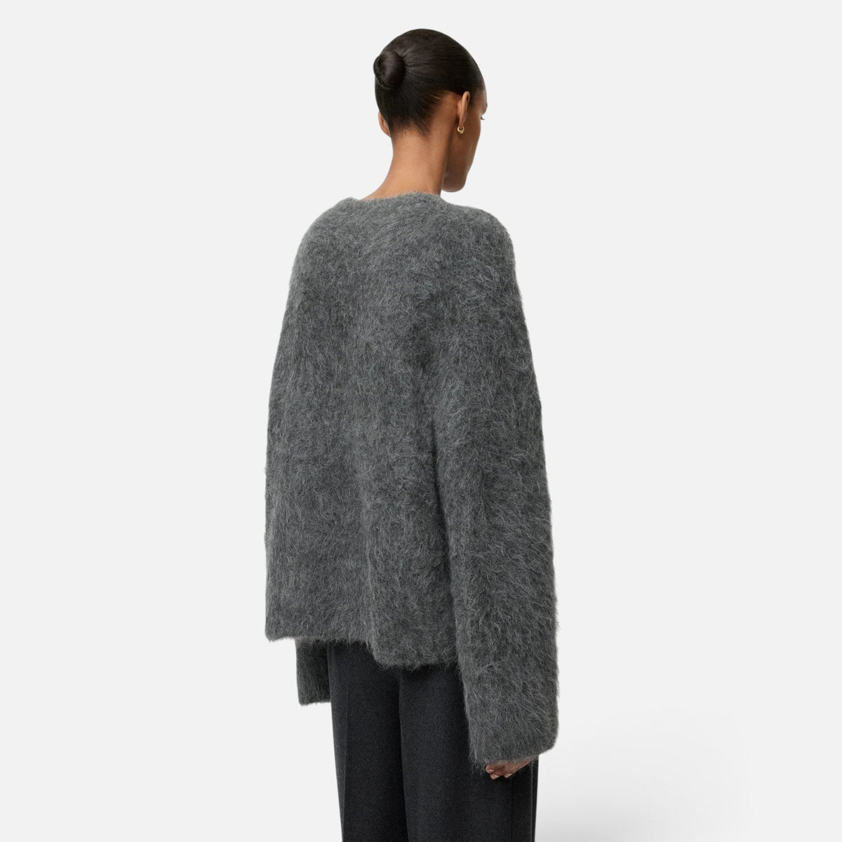 Shop Rescue Spa grey alpaca blend crewneck sweater with a relaxed fit and fuzzy knit texture, back view.