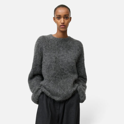 Shop Rescue Spa grey alpaca blend crewneck sweater with a relaxed fit worn by a model