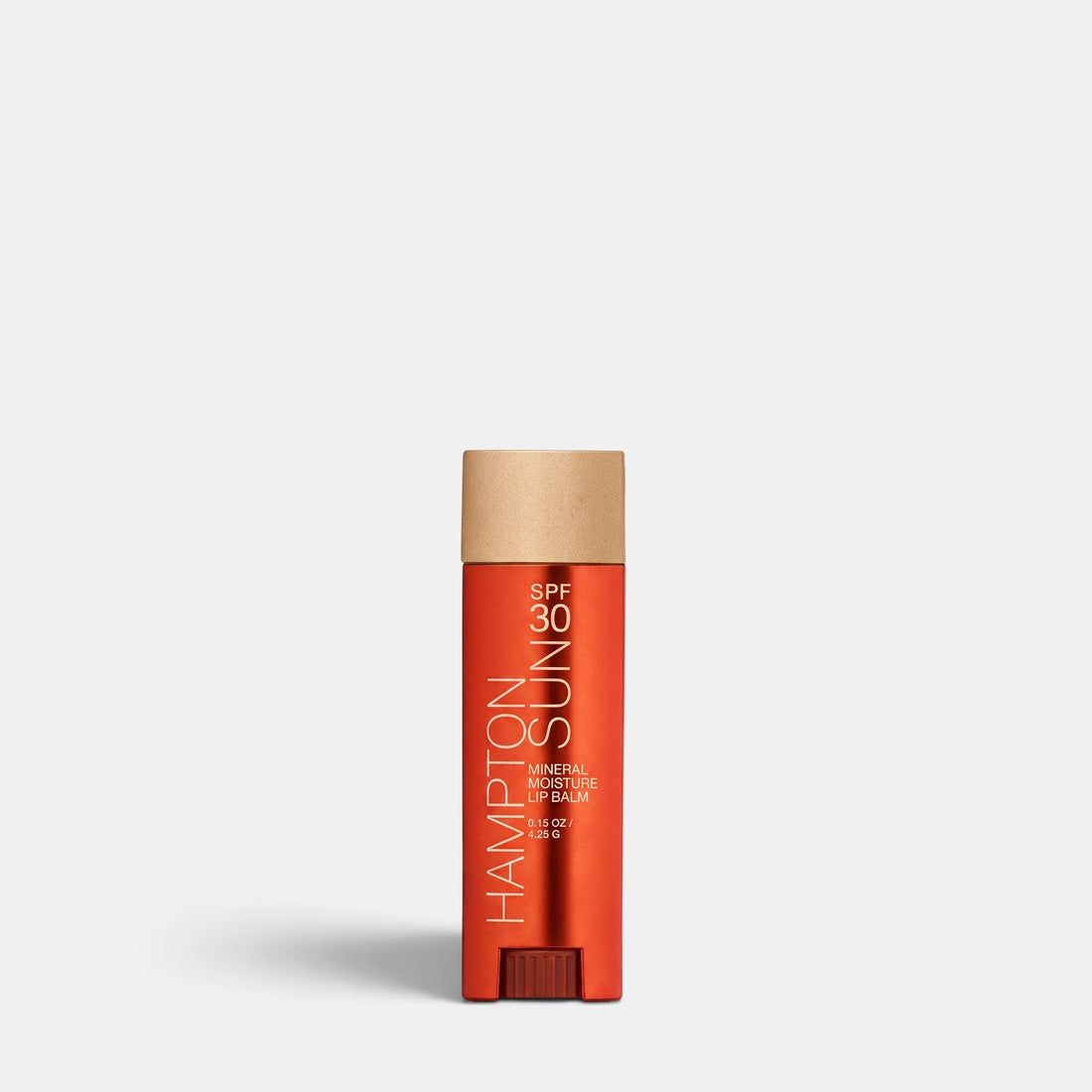 Shop Rescue Spa Hampton Sun SPF 30 mineral moisture lip balm in a sleek orange tube with a textured gold cap.