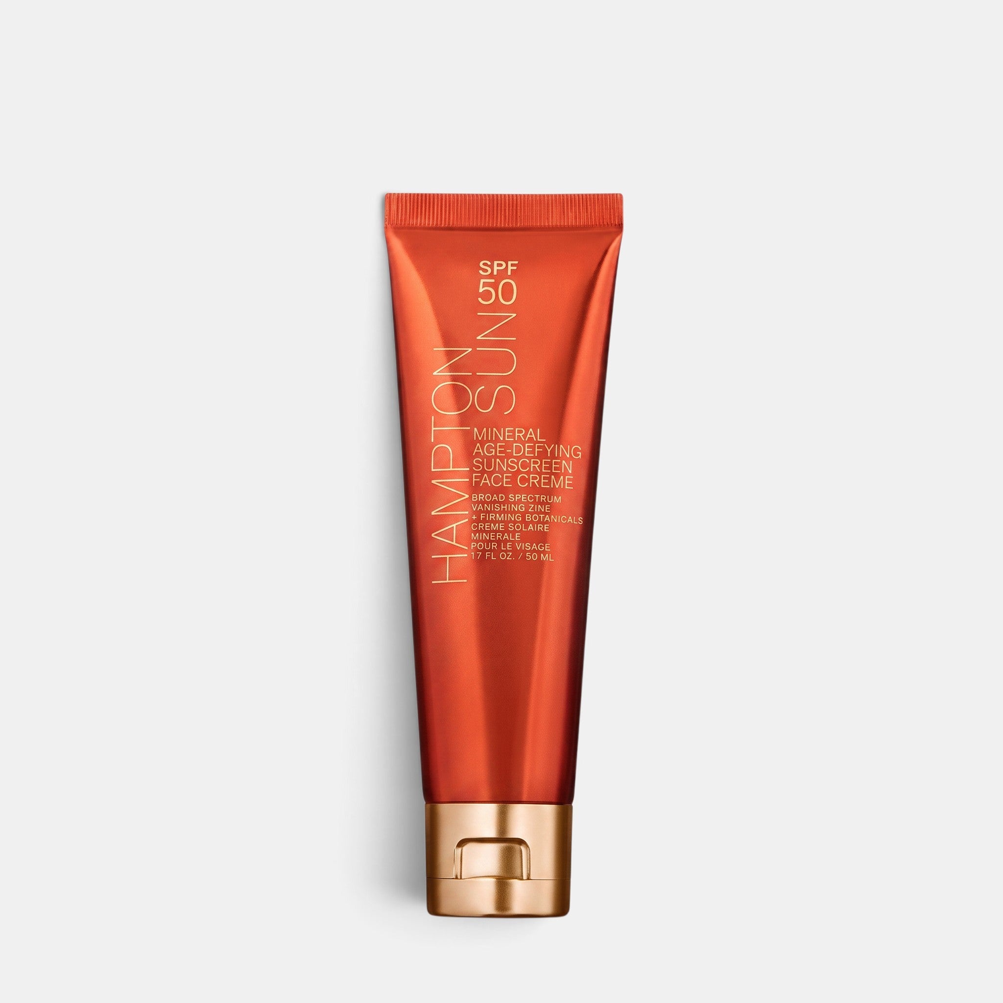 Shop Rescue Spa Hampton Sun SPF 50 mineral age-defying face crème in an orange squeeze tube with a gold cap.
